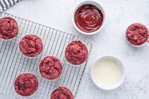Spiderman muffins beside bowls with melted dark and white chocolate
