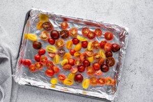 Cherry tomatoes cut in half on a foil