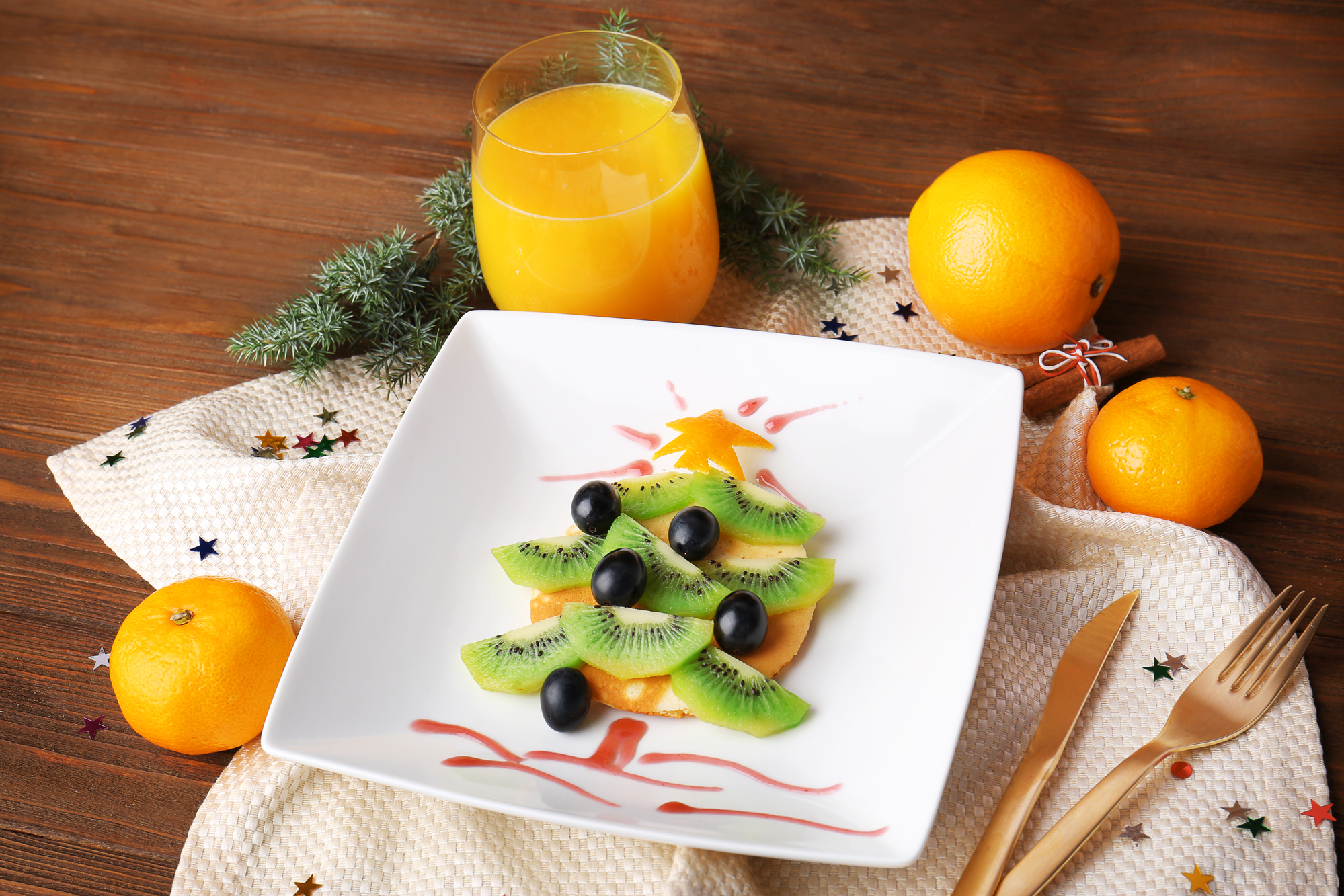 Christmas food idea for kids breakfast, on wooden background kiwi christmas tree food art