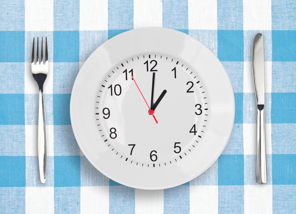 Plate as clock with fork and knife on the table