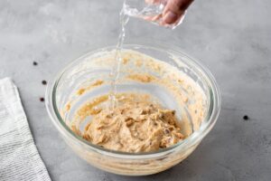 Adding water to pancake dough that's in the bowl