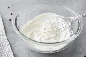 Greek yogurt whisked in a large bowl