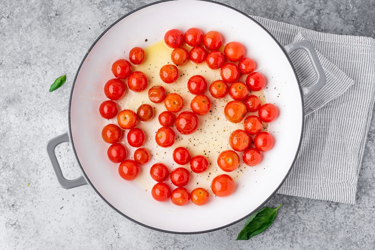 Cooking pan filled with cherry tomatoes and olive oil