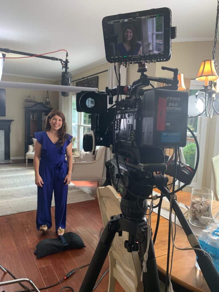 Erin Palinski wade behind camera on set for TV interview