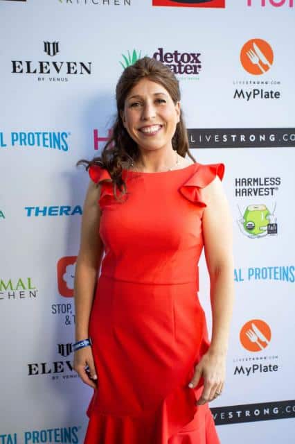 erin palinski wade poses for photo at press event