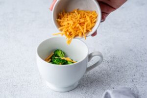 Adding Cheddar to the mug for easy microwave omelet