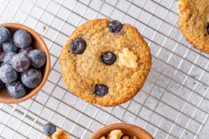 Oat Banana Blueberry Muffin with a bowl of blueberries
