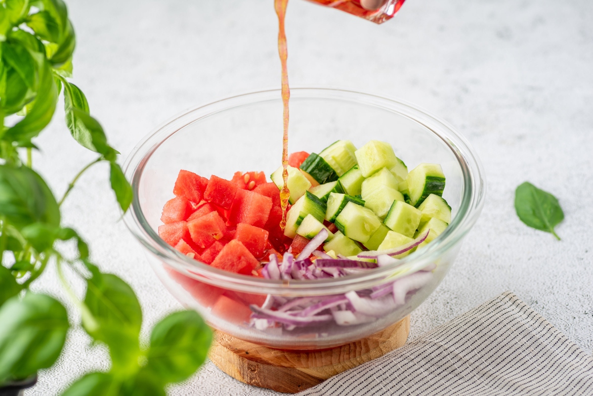 Adding dressing to Watermelon Salad with Coconut Rice