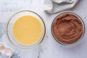 Liquid and dry ingredients in bowls for keto chocolate cake