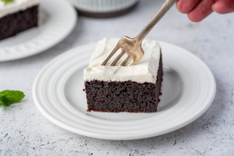 Piece of keto chocolate cake served on a plate with fork in it
