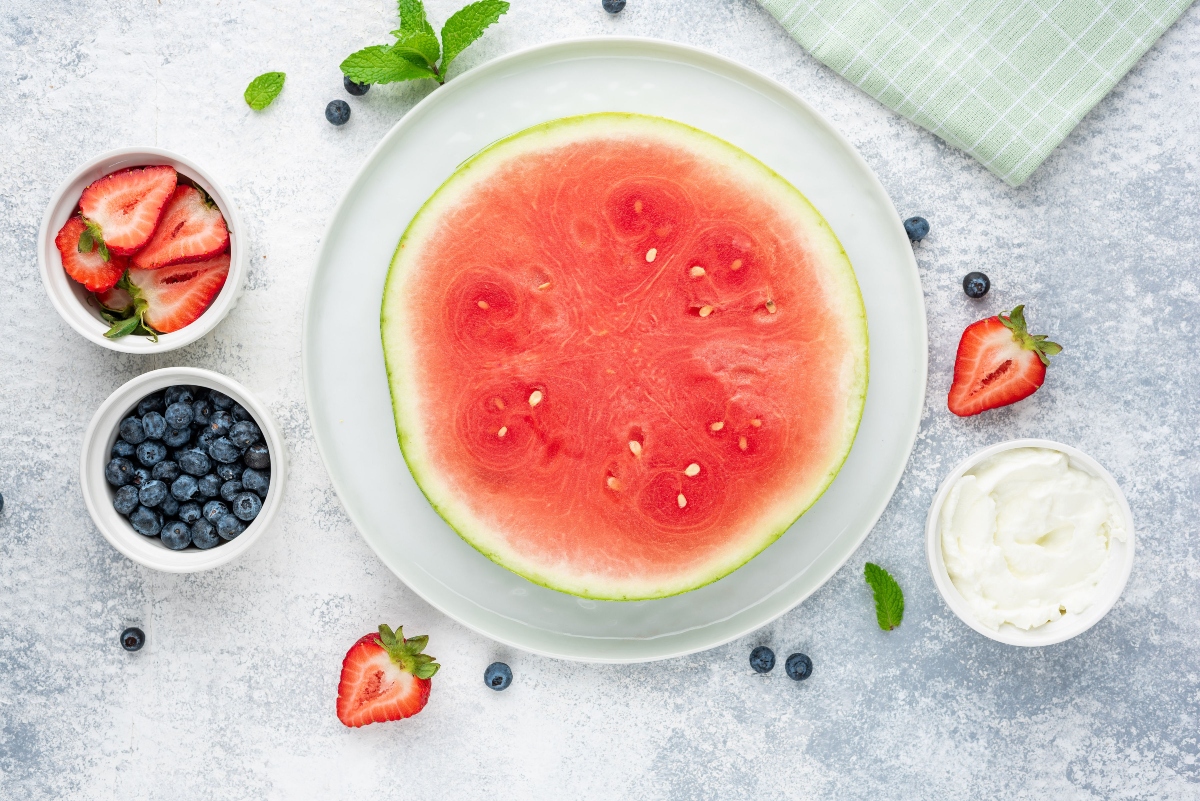 Food ingredients for Watermelon Pizza on the plate and in the cups