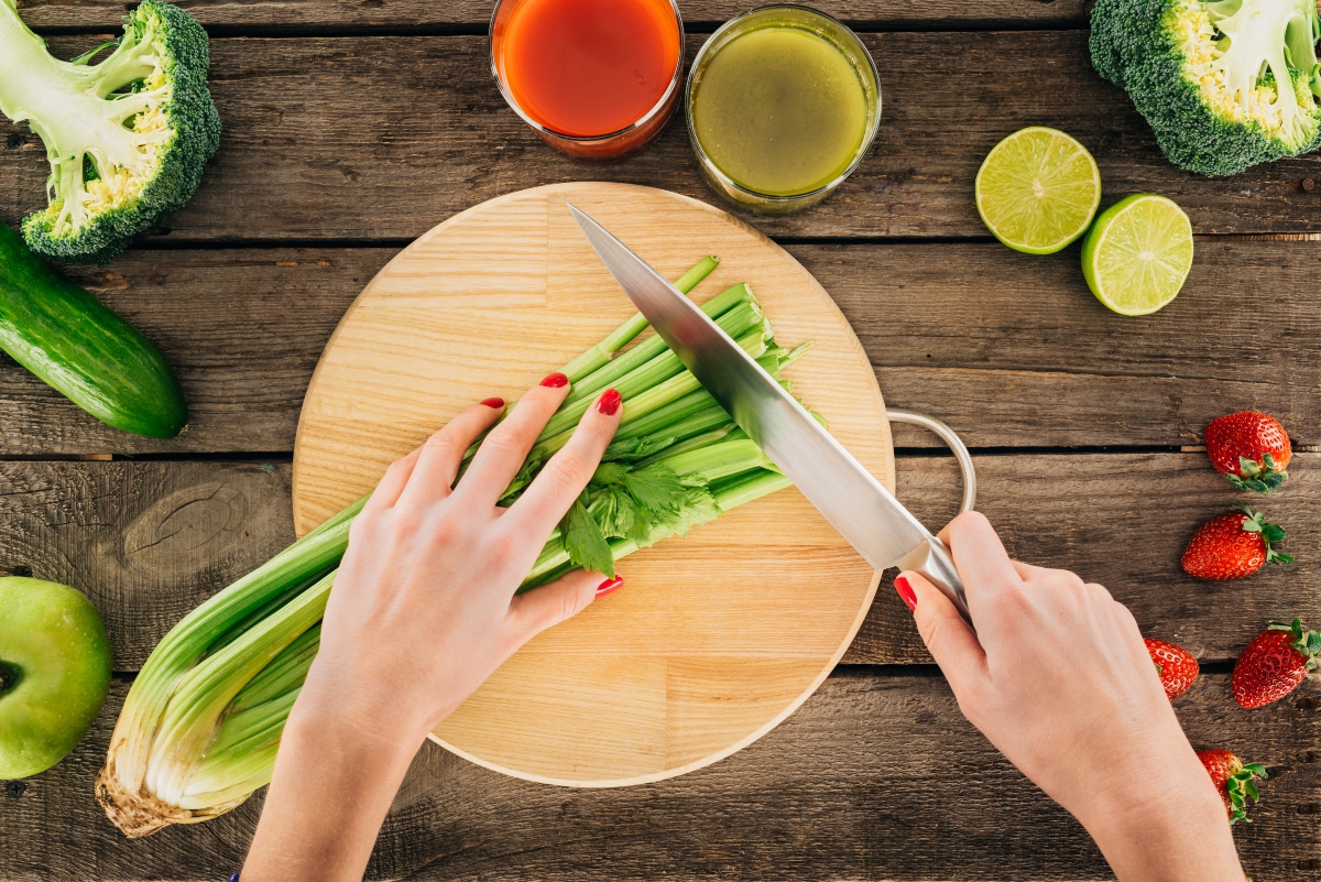 Woman cutting celery on cutting board