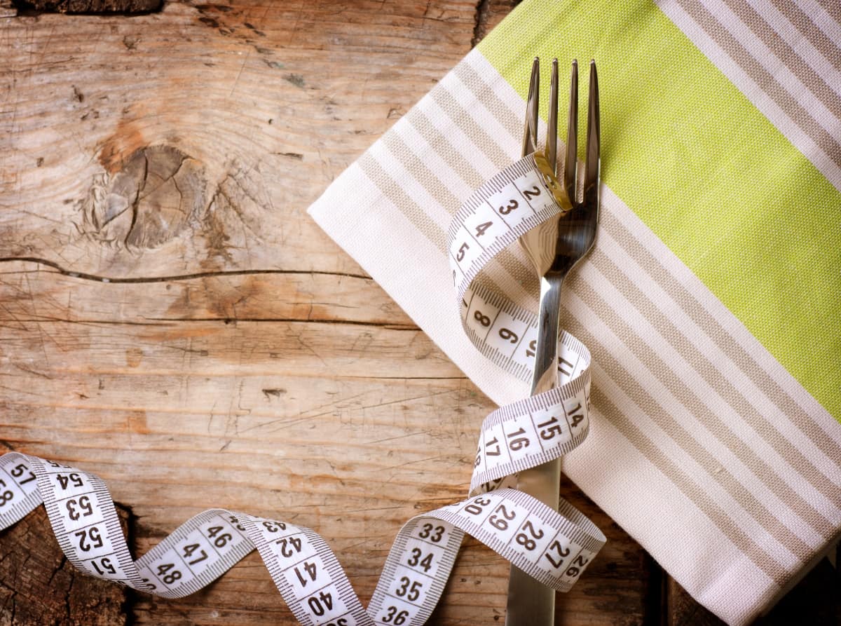 Fork and measuring tape on the cloth napkin