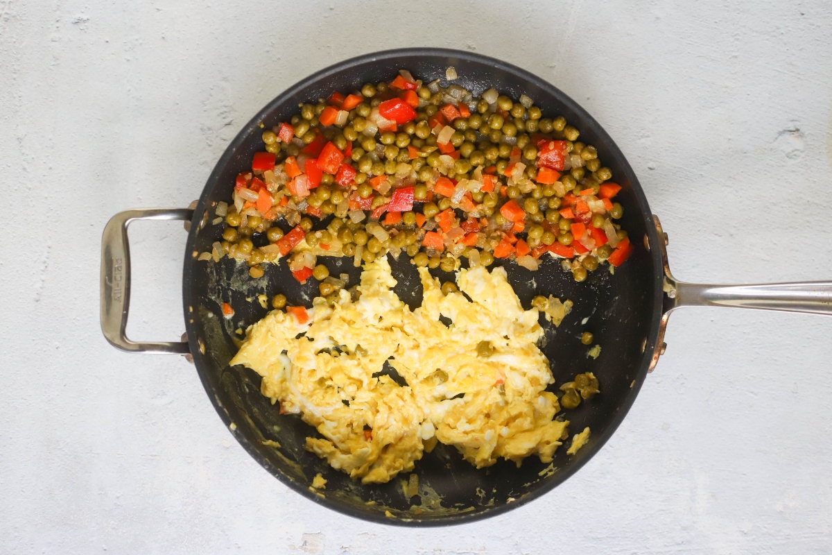 Pan with veggies on one side and rice on other