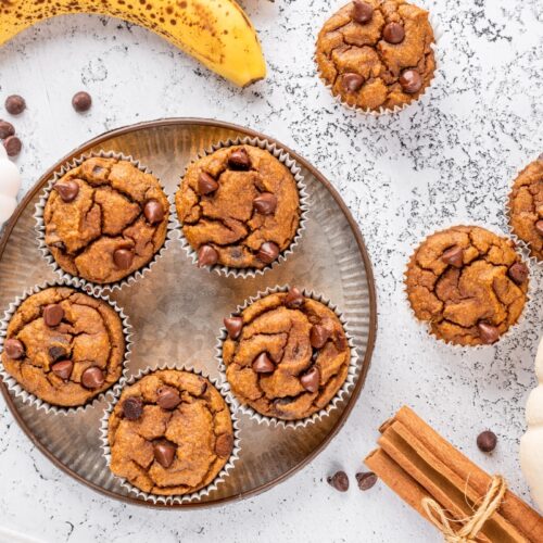 Low carb pumpkin muffins served on a plate with cinnamon stick and bananas around