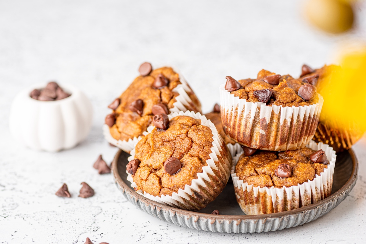 Stacked low carb pumpkin muffins on a round baking tray