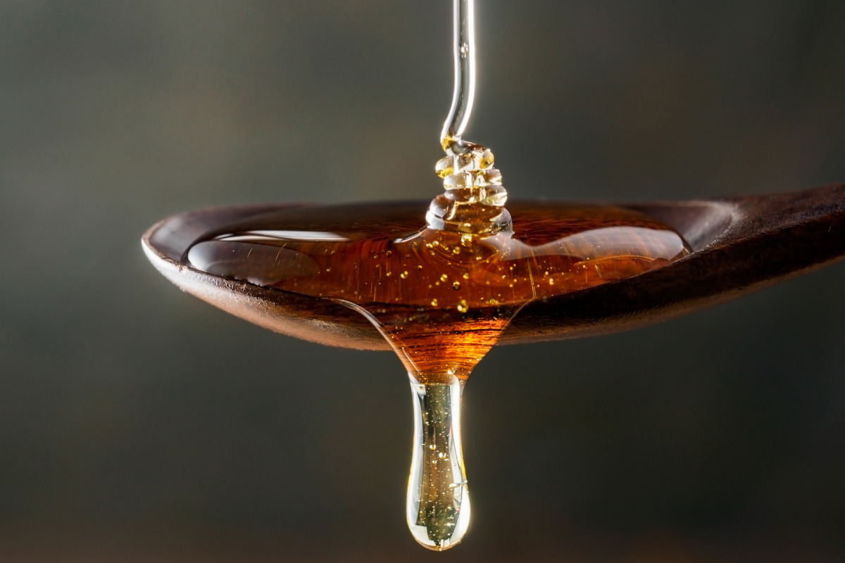 Honey or maple syrup in a wooden spoon