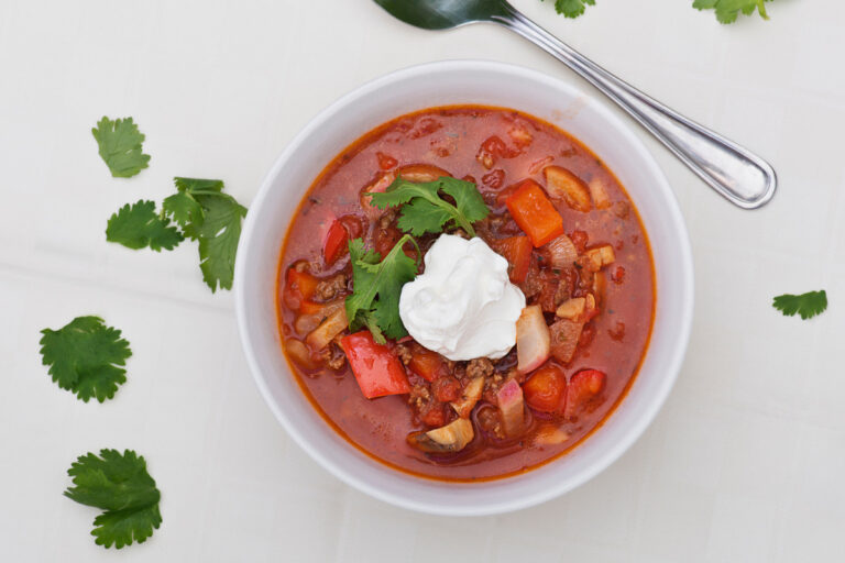 Low carb goulash soup served in a white bowl