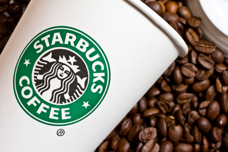 Starbucks cup with coffee beans
