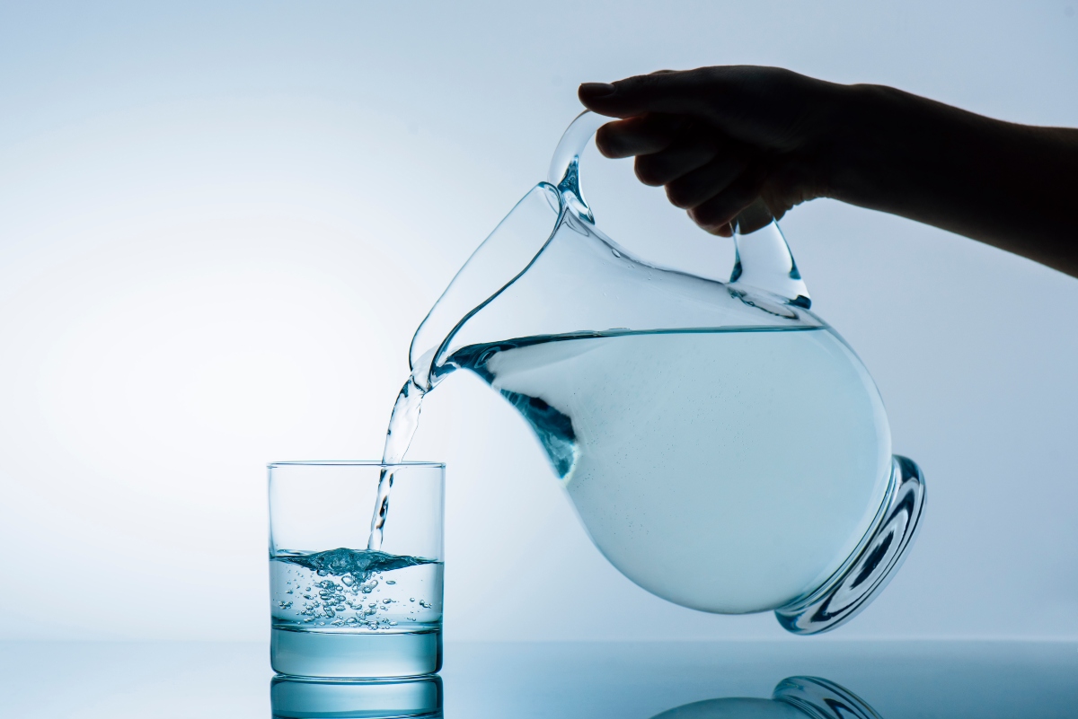Woman pouring water from jug