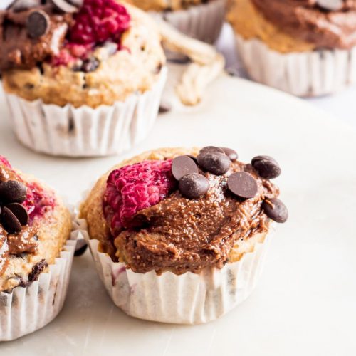 Several raspberry chocolate cupcakes topped with chocolate frosting and chocolate chips