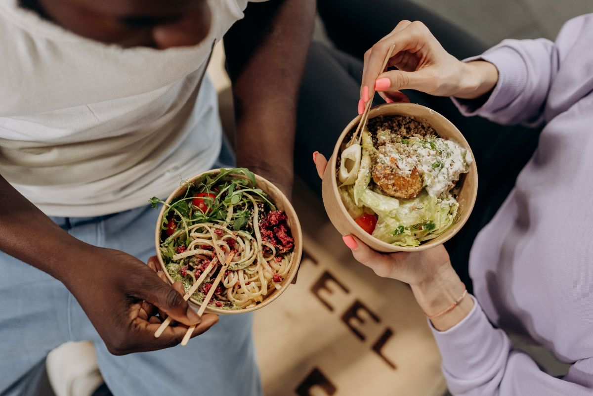 Top down view of two women eating a healthy lunch