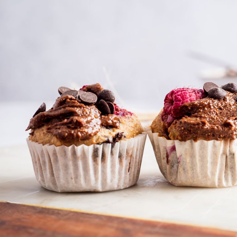 Two raspberry chocolate cupcakes with chocolate frosting