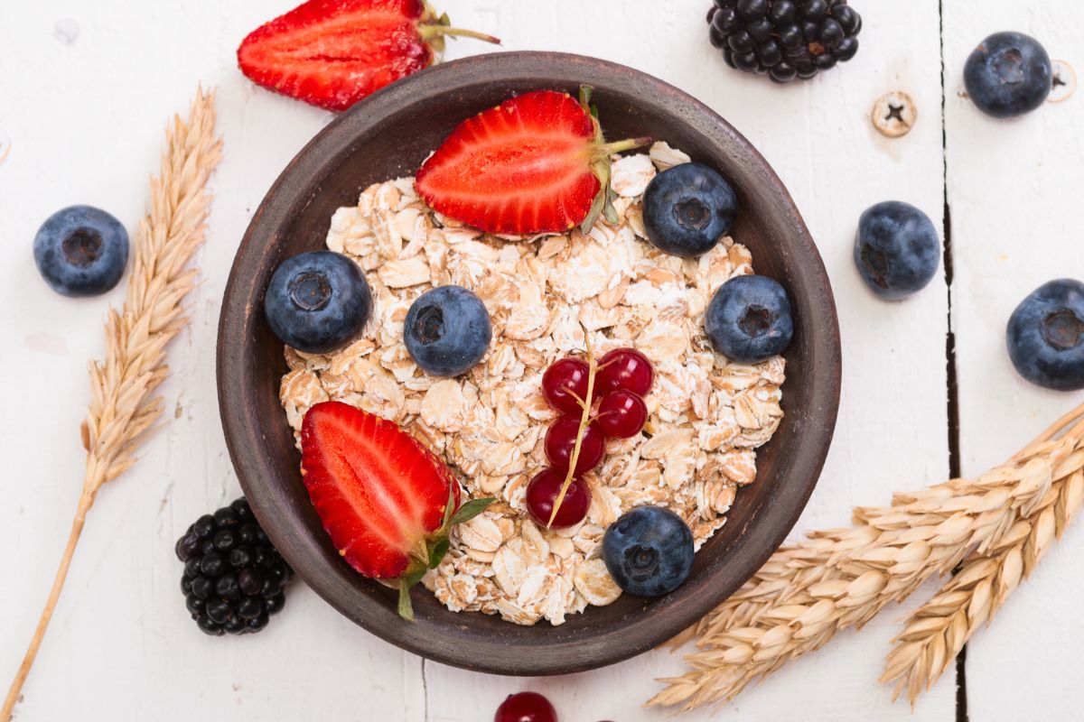 A black bowl with cereals and various berries