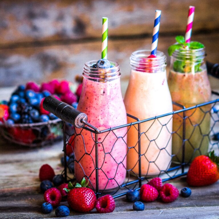 Three smoothies lined up on a table