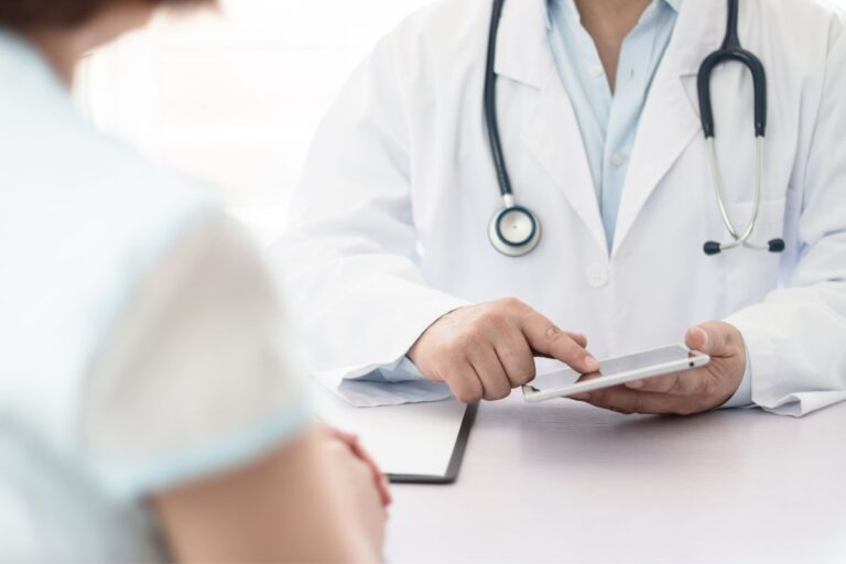 Doctor explaining a patient on a tablet how A1C is calculated