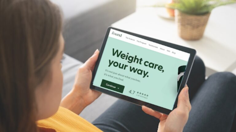 Woman looking at tablet with Found Weight Loss Program app