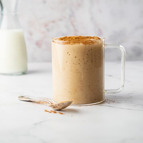Sea moss drink in a glass mug with a spoon beside