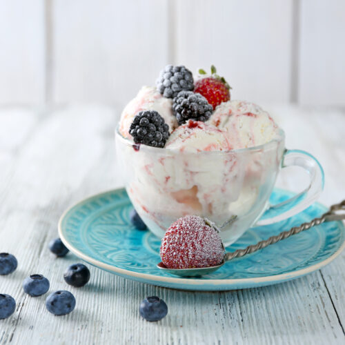 bowl of frozen cottage cheese ice cream topped with frozen berries