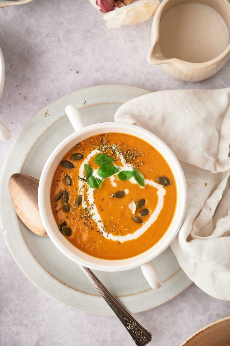 A bird's eye view of the butternut squash soup in a white bowl