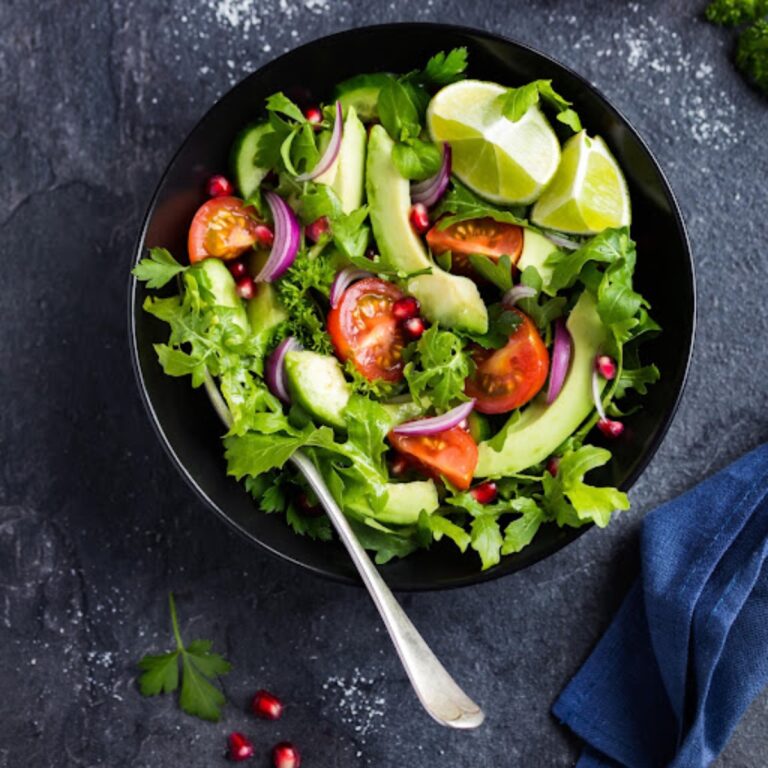 Avocado salad in a black bowl