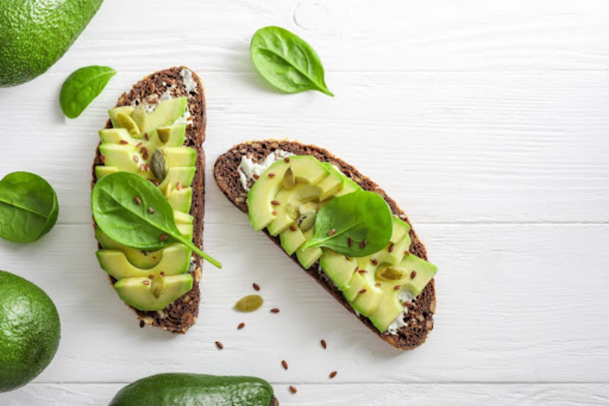 Avocado toast with fresh spinach leaves