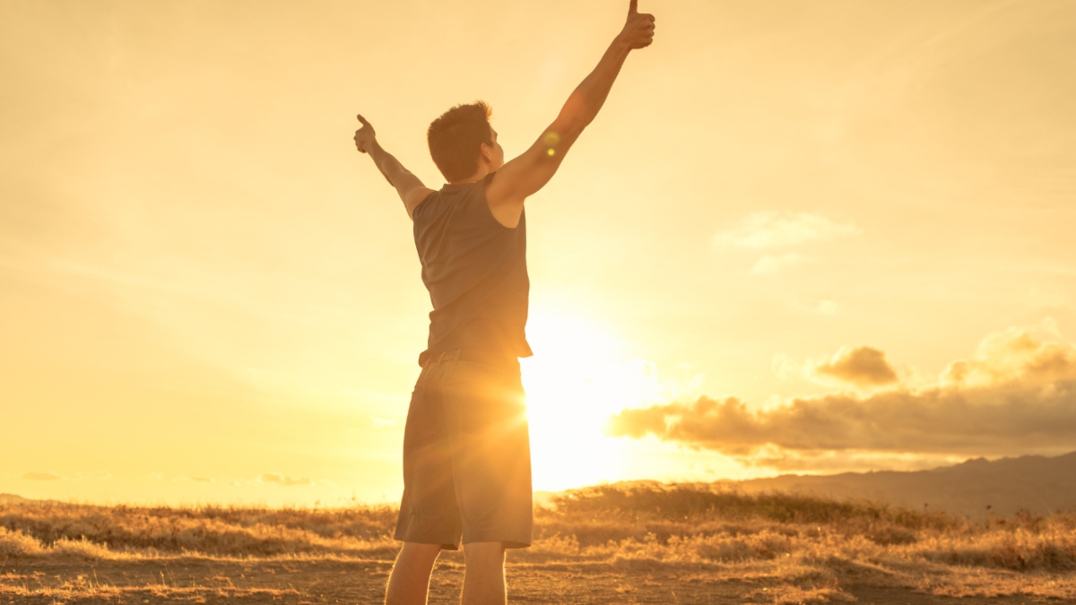 Men holding thumbs up in the sun