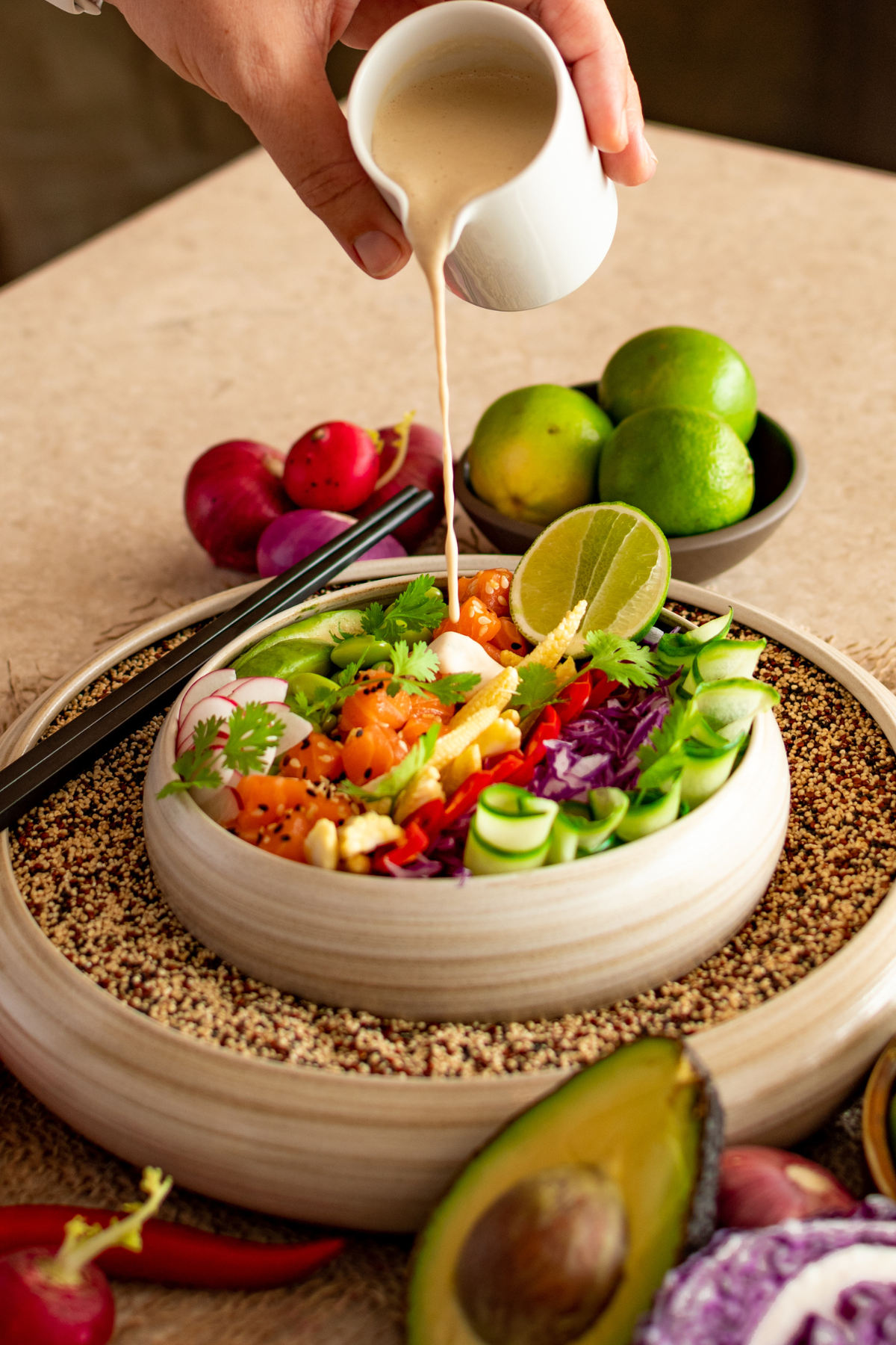 Person adding dressing to salad