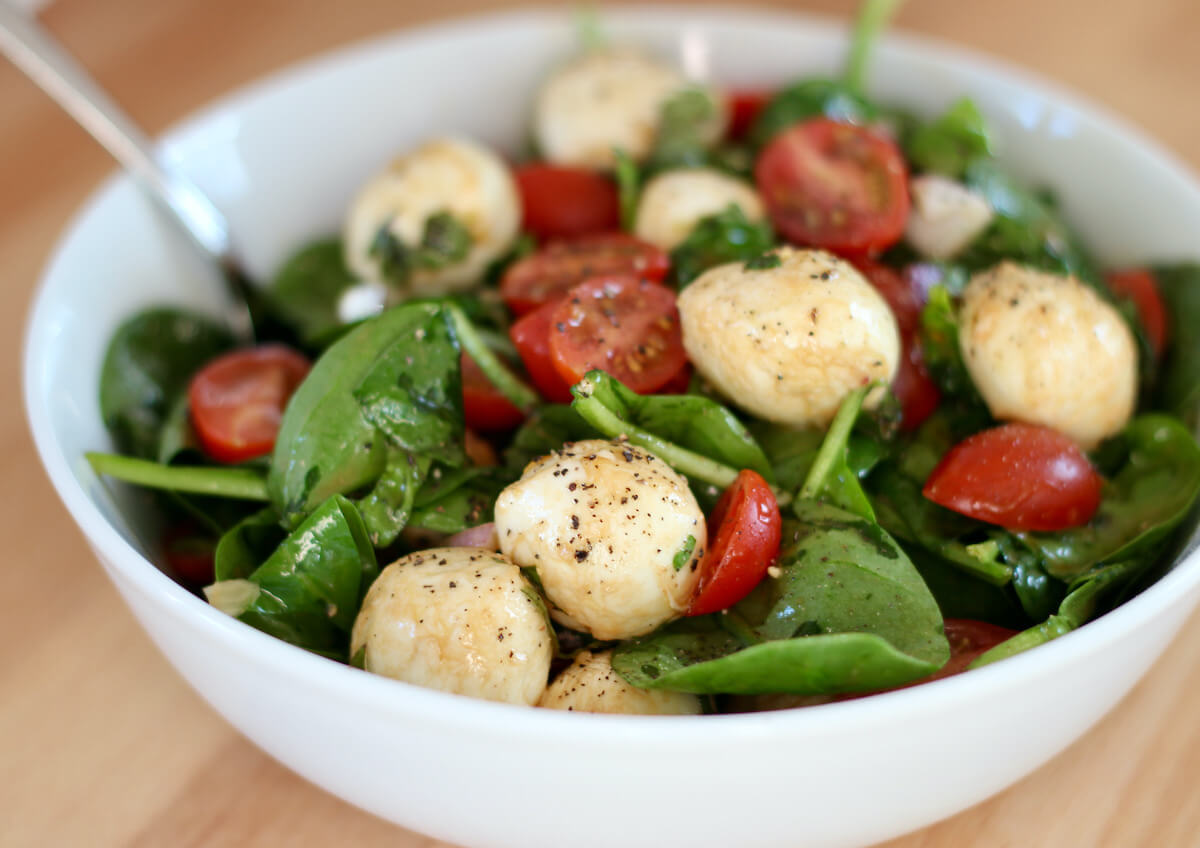 Spinach caprese salad in a bowl