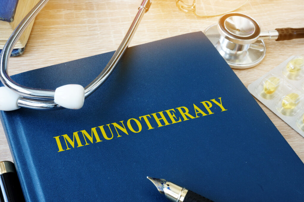 textbook displaying the words immunotherapy with a stethoscope laying on top