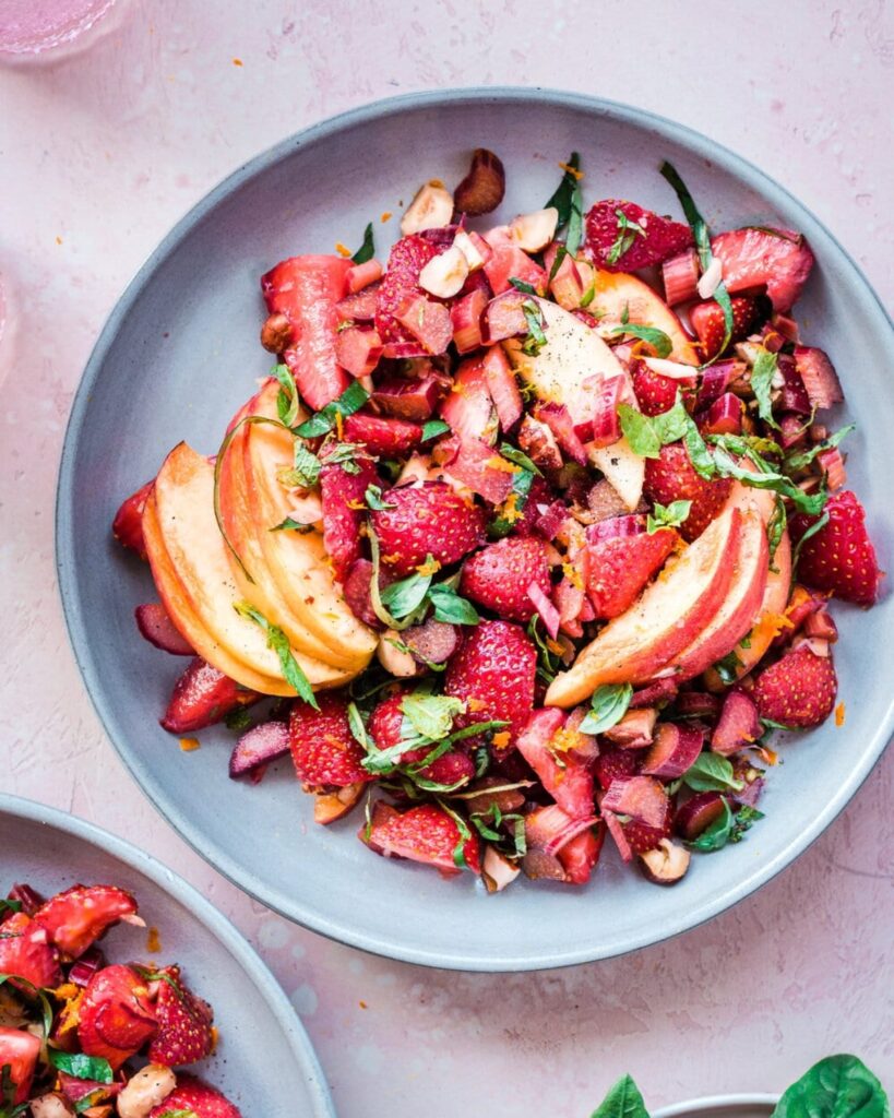 Healthy vegan strawberry rhubarb salad served in a blue bawl