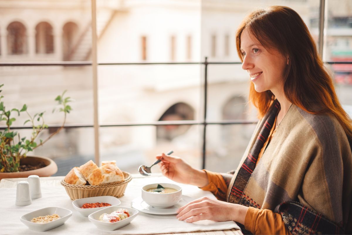 Woman eating a lentil soup