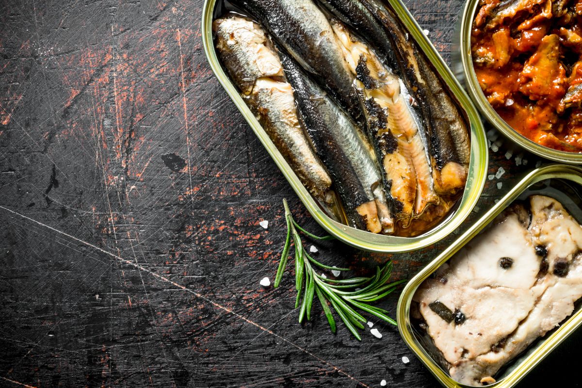 Canned fish in tin cans of rosemary