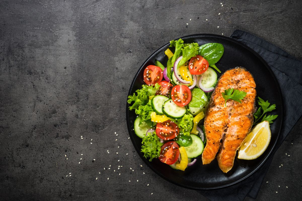 Salmon and vegetables in a black bowl