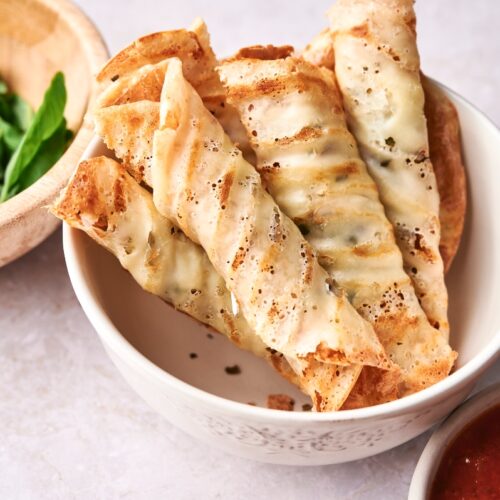 Keto pizza rolls in a white bowl