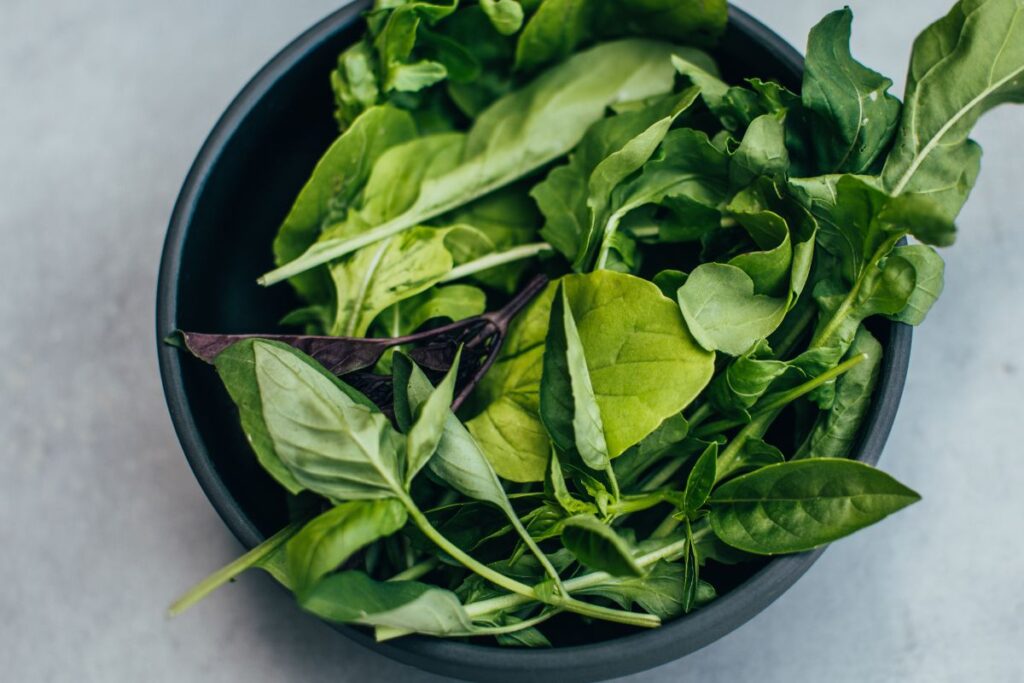 Green leafy vegetables in a black bowl