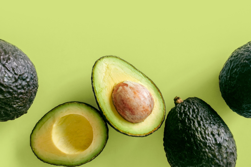 Avocados on green surface
