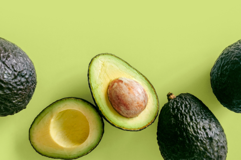 Avocados on green surface
