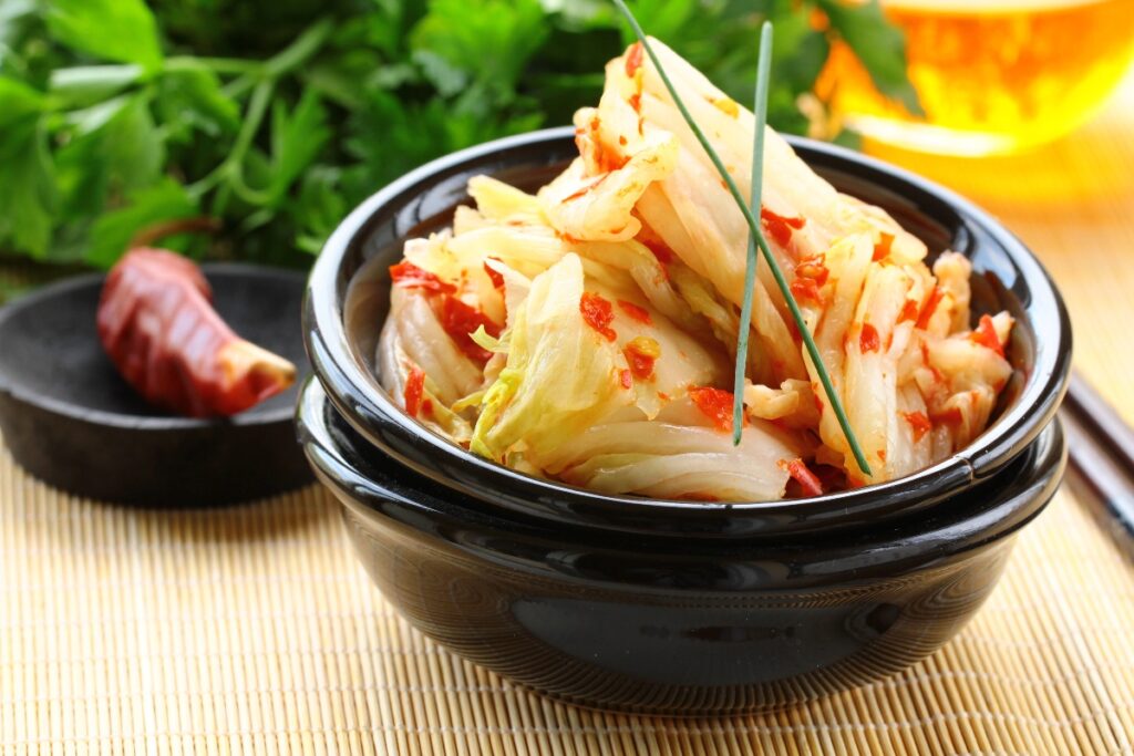 Kimchi with Napa Cabbage in a black bowl