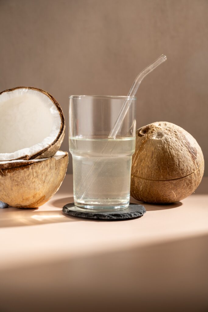 Pouring fresh coconut water in a glass